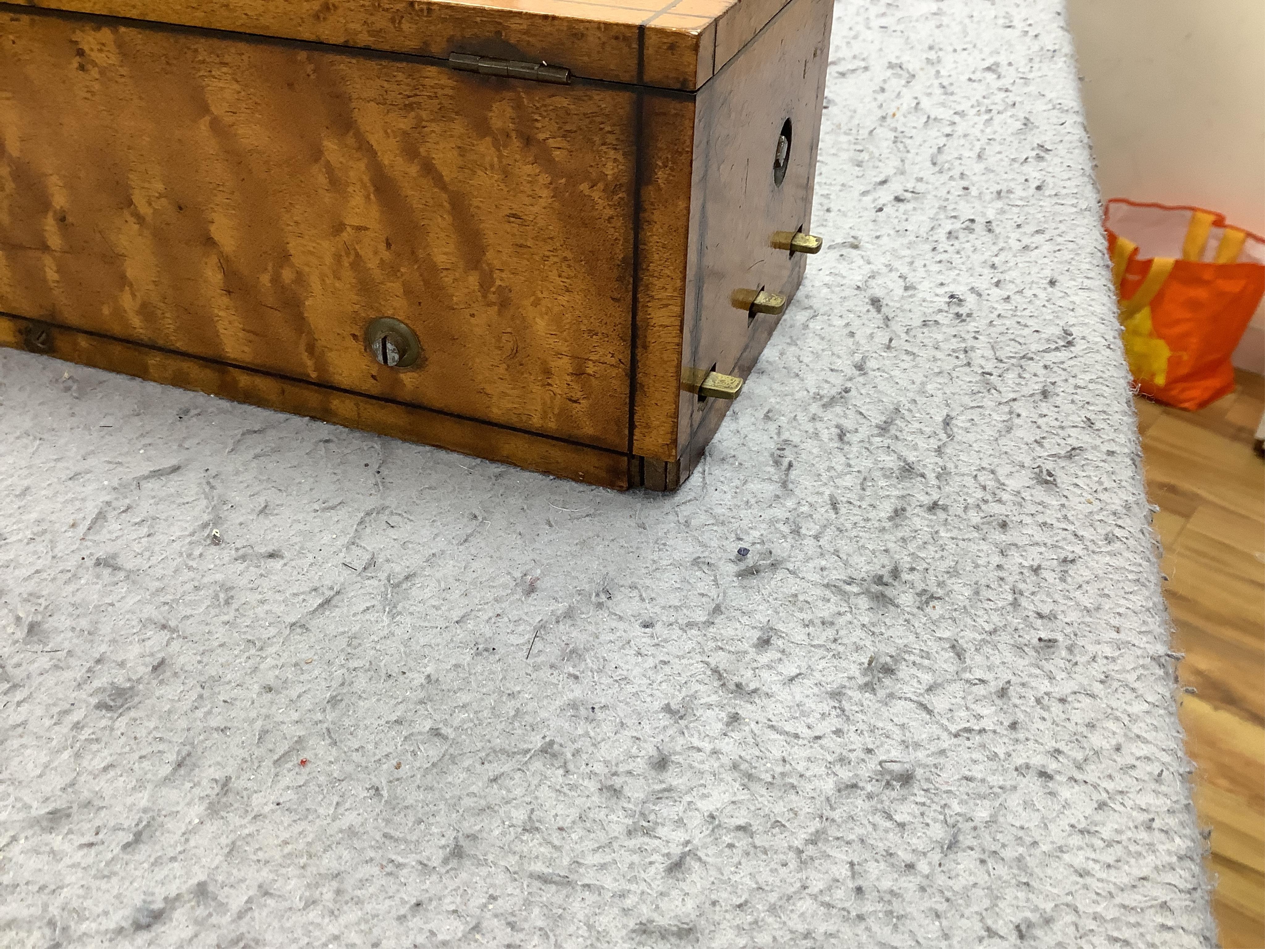 A small mid 19th century Swiss musical box in a bird’s eye maple case, side key wound, 30cm wide. Condition - fair.